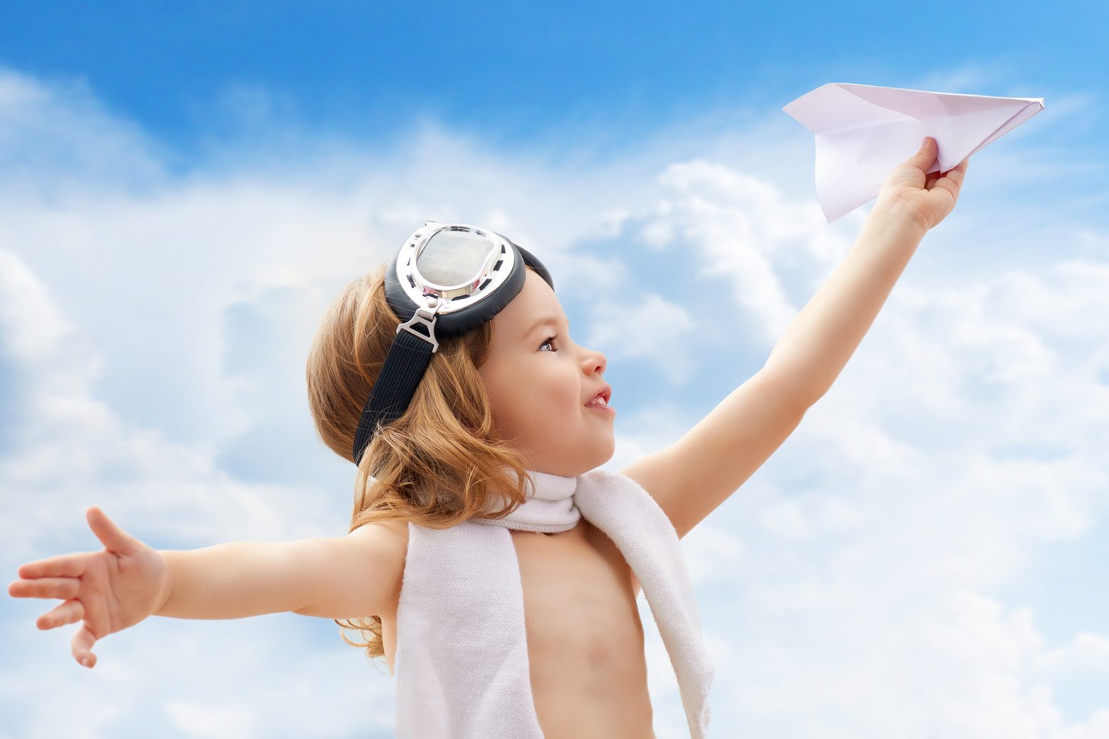 A child plays an airplane pilot